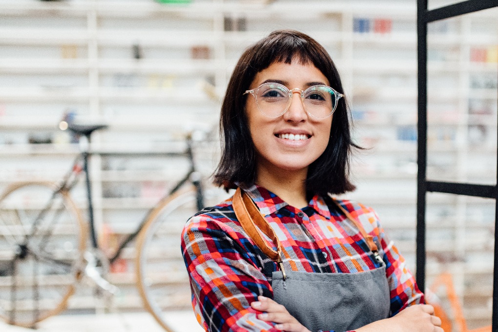 Entrepreneure souriante dans son atelier de réparation de vélos