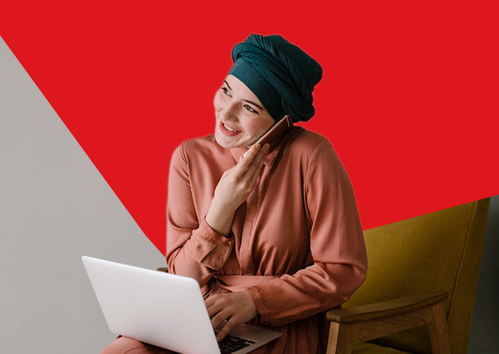 Photo d’une femme avec un ordinateur portable heureuse de trouver des conseils pour ses finances personnelles sur le site de la Banque Nationale